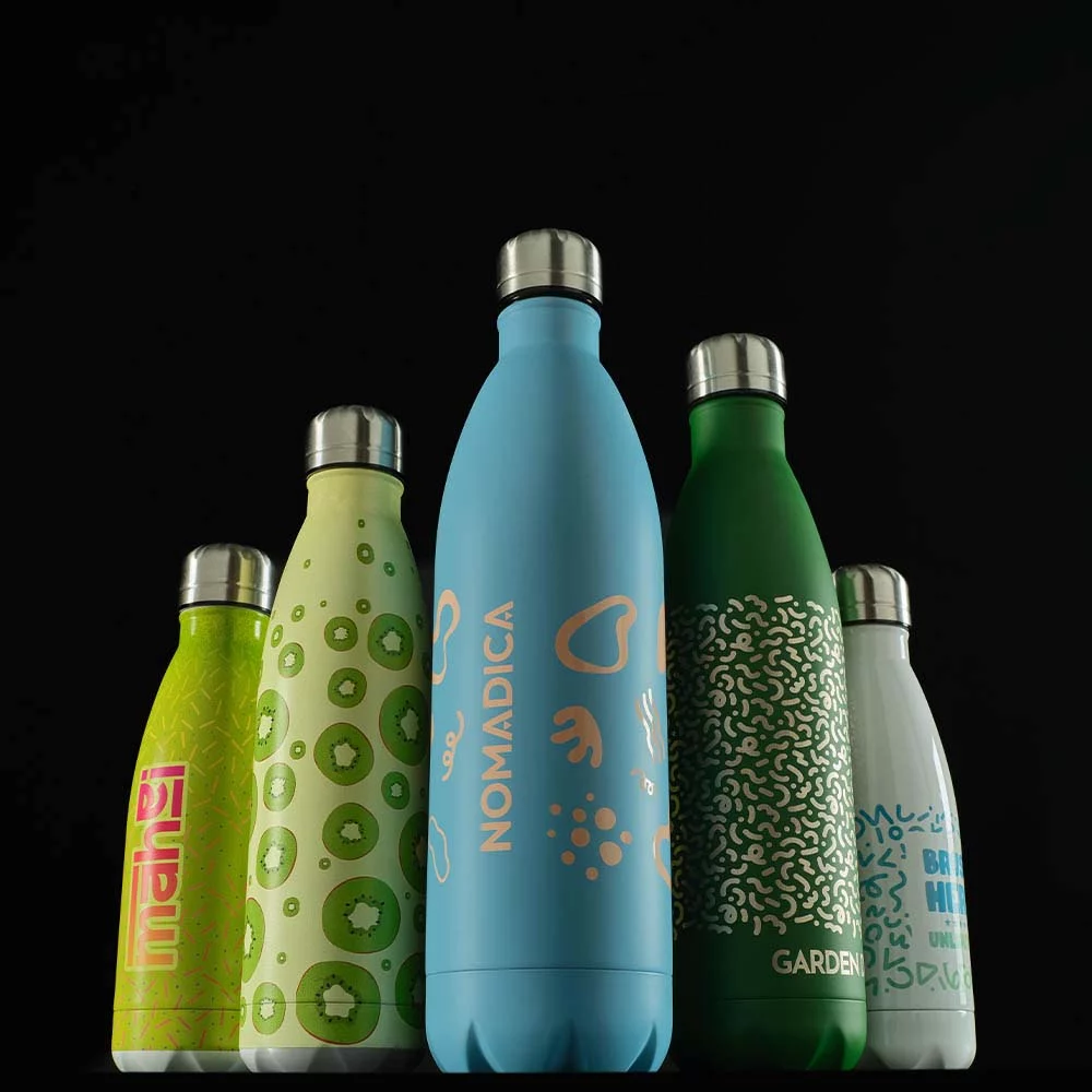 Cinq bouteilles réutilisables colorées avec bouchons en acier inoxydable alignées sur fond noir